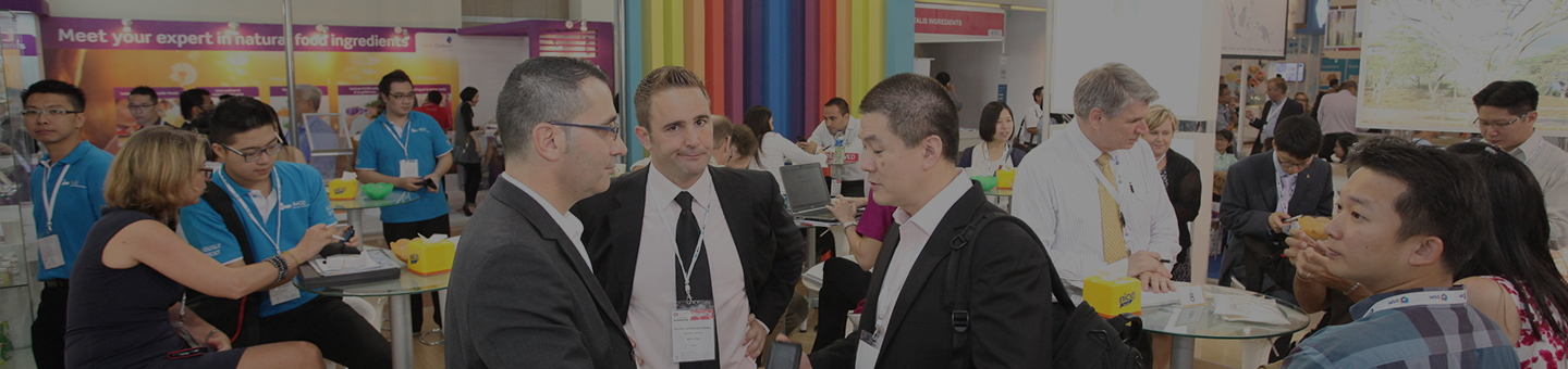Exhibitors talking with visitors at Fi Asia