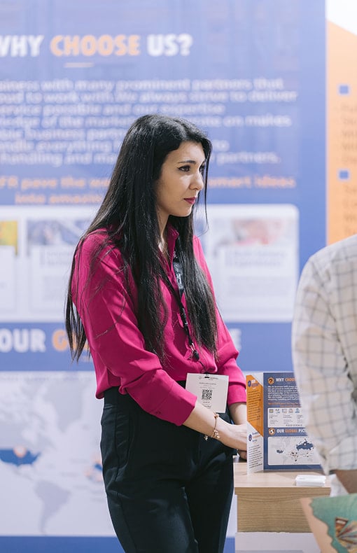 Exhibitor speaking while attendee listens at Fi Africa.