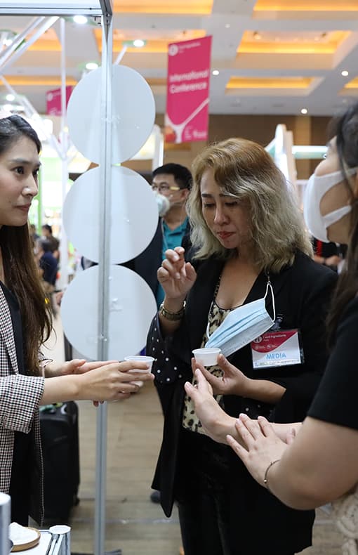 Visitor speaking to exhibitor at Fi Asia Indonesia
