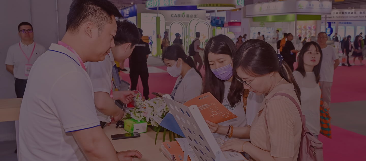 Visitors observing a booth at Fi China