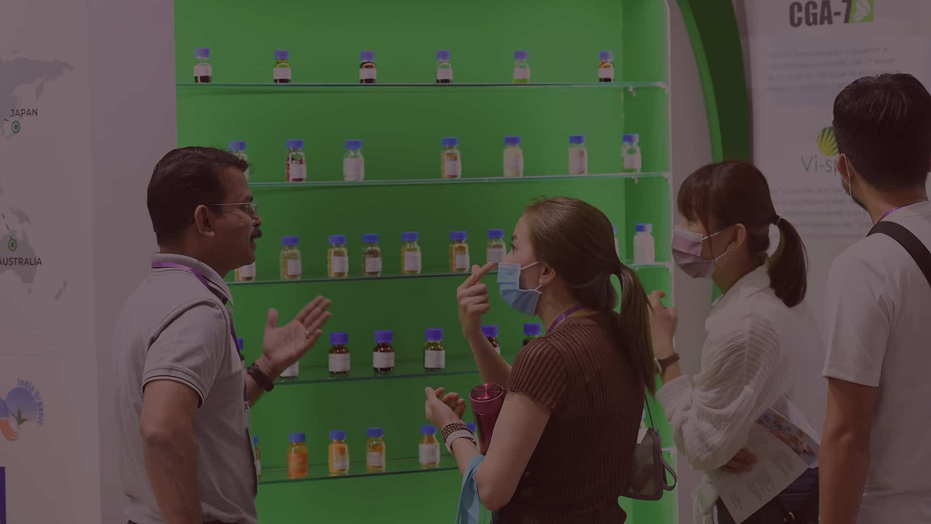 Visitors talking in front of products on shelf at Fi Vietnam