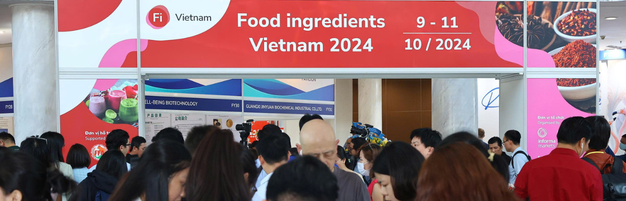 People walking along showroom floor at Fi Vietnam