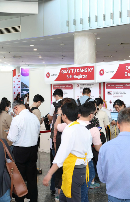 Visitors posing with award signs at Fi Vietnam
