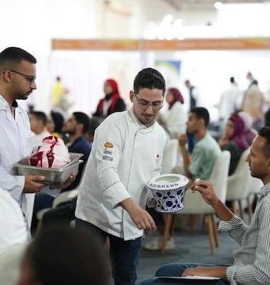 Fi Africa exhibitor handing out samples