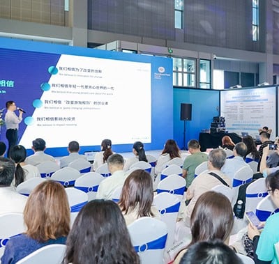 In a conference, visitors are listening to the speaker.