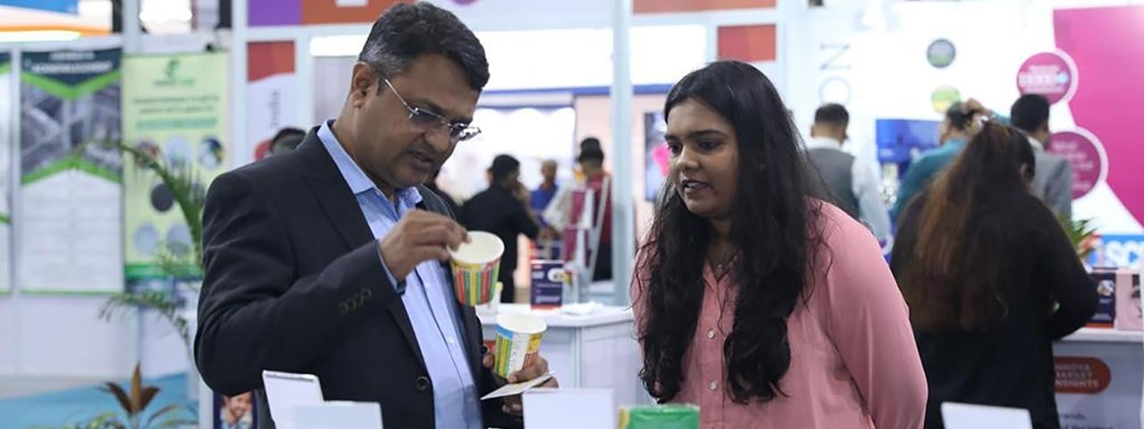 Exhibitor showing visitor a product