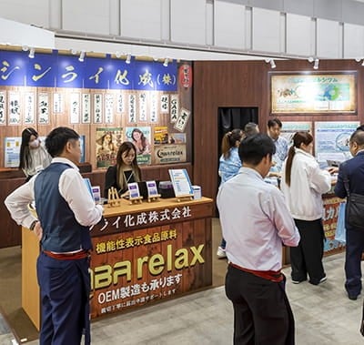 Visitor walking in front a stand