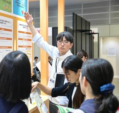 Visitors looking at exhibitor stand at Hi Japan