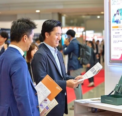 Visitors inspecting product descriptions at Hi Japan