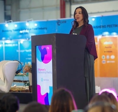 Speaker on stage at the women's networking breakfast at Fi South America