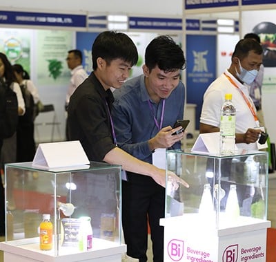 visitors taking photos of products in glass case